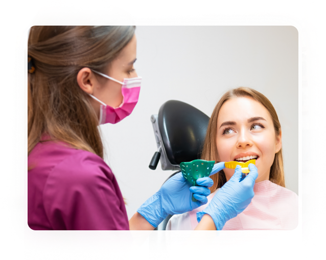 Dentist taking an impression of a patient’s teeth