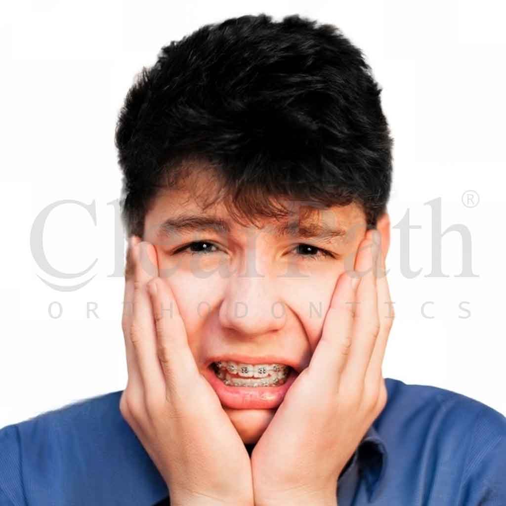 A man experiencing discomfort and braces pain.